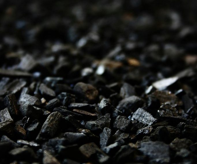 Detailed close-up of charcoal briquettes showing textures and shades.