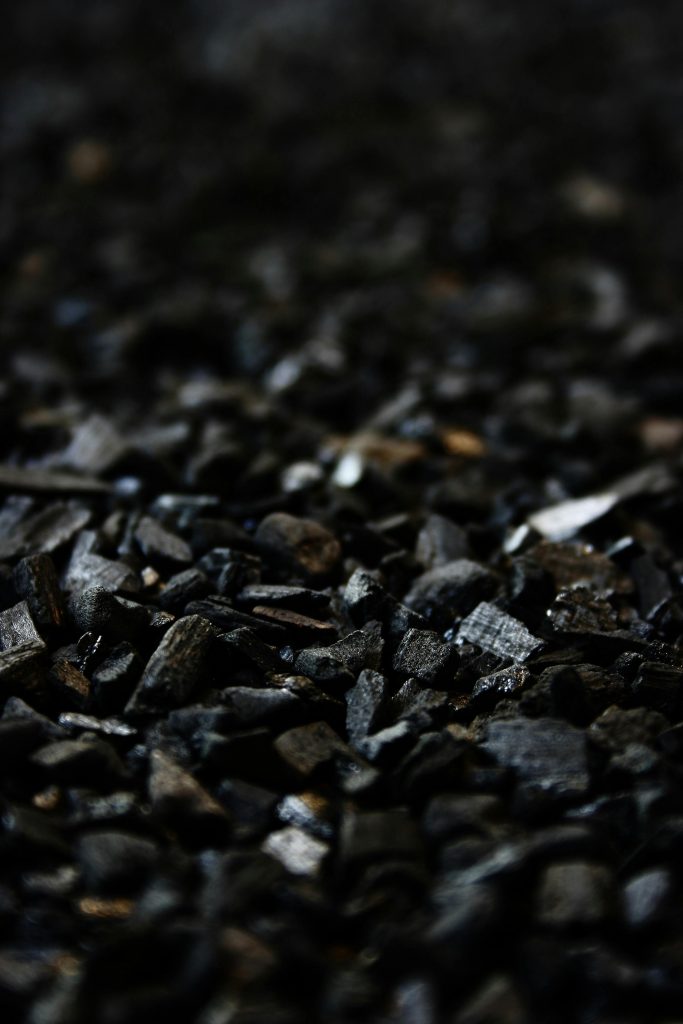 Detailed close-up of charcoal briquettes showing textures and shades.
